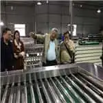 Indonesian customers watching the mangosteen processing machine